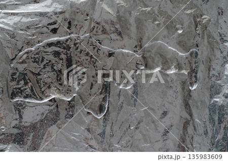 Light wet aluminum foil texture with soft reflections Light wet aluminum foil texture with soft reflections 135983609