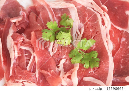 slice brisket beef raw food topping parslty arrangig in plate on table 135986654