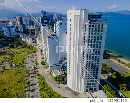 Flying over a coastal city. 135991166