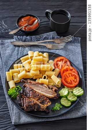 roasted pork ribs with pasta and fresh vegetables 135991338
