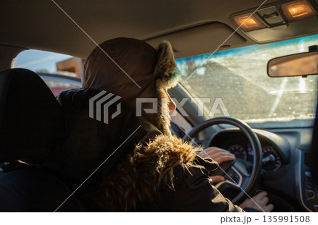 Man driving car during winter. Daily commute on cold day. Winter driving concept. Road trip adventure. Taxi, delivery Man driving car during winter. Daily commute on cold day. Winter driving concept. Road trip adventure. Taxi, delivery 135991508