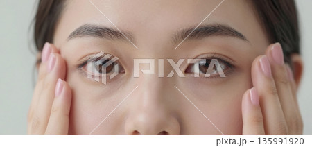 Close up beauty portrait of young woman touching face with clean natural skin skincare and wellness concept 135991920