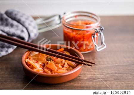 Fermented cabbage. Kimchi. Korean food in bowl on wooden table. Fermented cabbage. Kimchi. Korean food in bowl on wooden table. 135992914