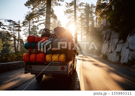 Colorful Flatbed Truck Carrying Adventure Gear Through Scenic Mountain Road at Sunrise Colorful Flatbed Truck Carrying Adventure Gear Through Scenic Mountain Road at Sunrise 135993311