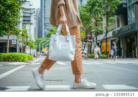 Stylish Woman Walking in City with Unbranded White Tote Bag 135993515