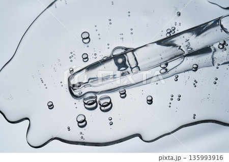 Pipette tip drawing transparent liquid with active bubbles 135993916