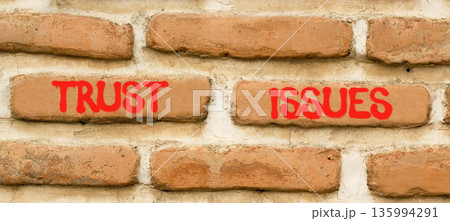 Trust issues symbol. Concept word Trust issues on beautiful old brown brick wall. Beautiful old brown brick wall background. Old brick wall. Business trust issues concept. Copy space. Trust issues symbol. Concept word Trust issues on beautiful old brown brick wall. Beautiful old brown brick wall background. Old brick wall. Business trust issues concept. Copy space. 135994291