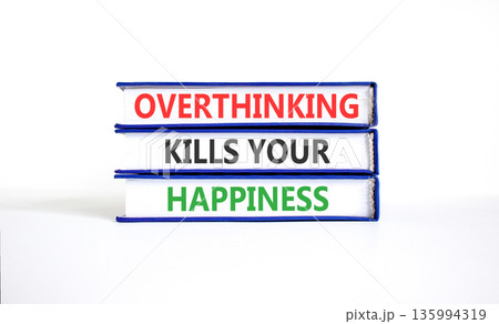Overthinking kills your happiness symbol. Concept words Overthinking kills your happiness on books. Beautiful white paper background. Business overthinking kills happiness concept. Copy space. Overthinking kills your happiness symbol. Concept words Overthinking kills your happiness on books. Beautiful white paper background. Business overthinking kills happiness concept. Copy space. 135994319