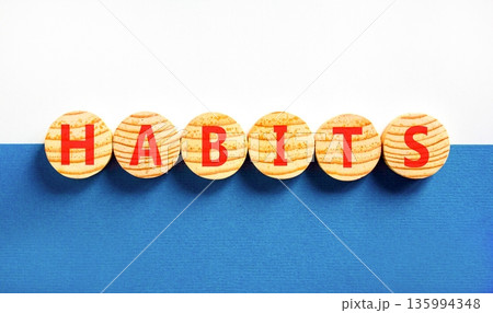 Habits support and help symbol. Concept word Habits on beautiful wooden circles. Beautiful blue and white background. Business psychological habits support and help concept. Copy space. Habits support and help symbol. Concept word Habits on beautiful wooden circles. Beautiful blue and white background. Business psychological habits support and help concept. Copy space. 135994348
