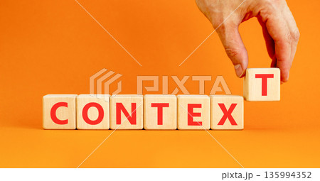 Context symbol. Concept word Context on beautiful wooden blocks. Beautiful orange background. Businessman's hand. Business context concept. Copy space. 135994352