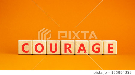Courage symbol. Concept word Courage on beautiful wooden blocks. Beautiful orange background. Business courage concept. Copy space. 135994353