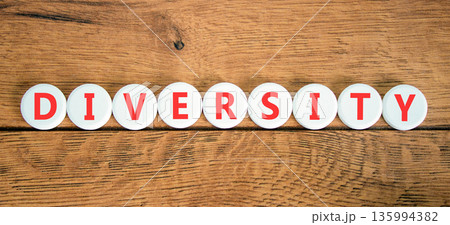 Diversity symbol. Concept words Diversity on beautiful white circles. Beautiful wooden background. Business support diversity DEI concept. Copy space. Diversity symbol. Concept words Diversity on beautiful white circles. Beautiful wooden background. Business support diversity DEI concept. Copy space. 135994382
