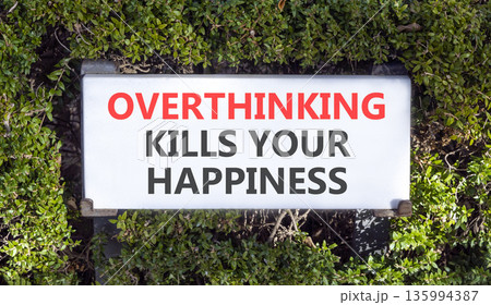 Overthinking kills your happiness symbol. Concept words Overthinking kills your happiness on road sign. Beautiful green trees background. Business overthinking kills happiness concept. Copy space. Overthinking kills your happiness symbol. Concept words Overthinking kills your happiness on road sign. Beautiful green trees background. Business overthinking kills happiness concept. Copy space. 135994387