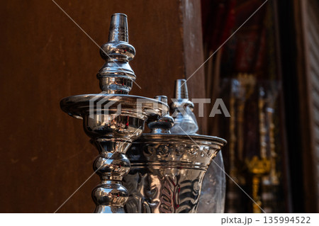 A shop in Khan El Khalili market, Cairo, is selling colourful shisha pipes. The entrance displays various ornate shisha, showcasing traditional Egyptian craftsmanship. A shop in Khan El Khalili market, Cairo, is selling colourful shisha pipes. The entrance displays various ornate shisha, showcasing traditional Egyptian craftsmanship. 135994522