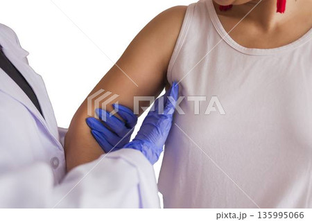 Doctor performing breast cancer screening examination 135995066