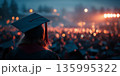 Graduation celebration viewed from behind with glowing lights in the distance 135995322