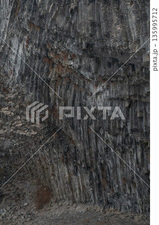 Vertical basalt columns create dense geometric textures at Symphony of Stones, dark volcanic rock forms dramatic natural patterns with layered depth Vertical basalt columns create dense geometric textures at Symphony of Stones, dark volcanic rock forms dramatic natural patterns with layered depth 135995712