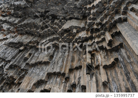 Vertical basalt columns form dense geometric patterns at the Symphony of Stones, dark volcanic rock creates dramatic texture and natural rhythm Vertical basalt columns form dense geometric patterns at the Symphony of Stones, dark volcanic rock creates dramatic texture and natural rhythm 135995737