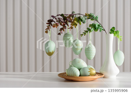 Hanging Easter Eggs and Spring Branches in Vase. Festive Pastel Decor 135995906