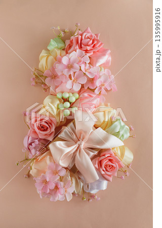 Floral Number Eight with Satin Bow. Elegant Womens Day Decoration on Pink Background Floral Number Eight with Satin Bow. Elegant Womens Day Decoration on Pink Background 135995916