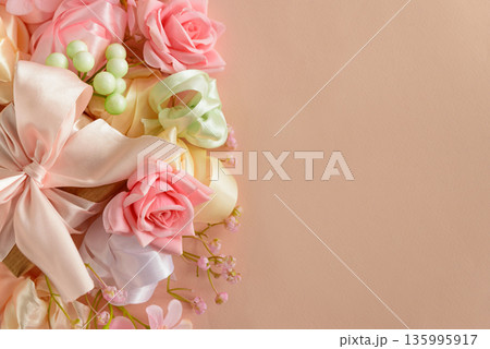 Floral Arrangement with Satin Bow on Peach Background. Elegant Womens or Mothers Day Greeting Composition 135995917