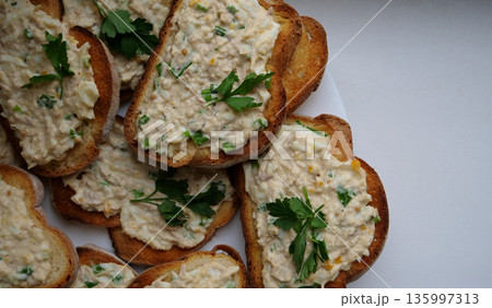 White plate with toast sandwiches with egg salad with mayonnaise and onion White plate with toast sandwiches with egg salad with mayonnaise and onion 135997313