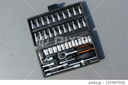 Chrome Vanadium Mechanics Tools In Separate Slots In Plastic Case On Gray Metal Surface Chrome Vanadium Mechanics Tools In Separate Slots In Plastic Case On Gray Metal Surface 135997508