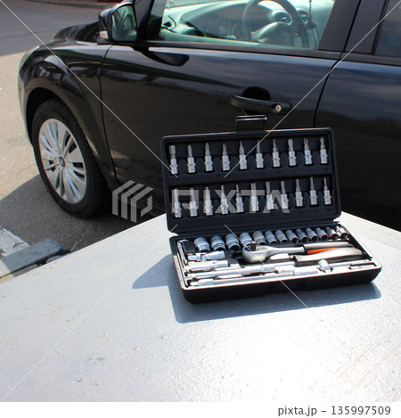Repairing Tools In Plastic Case On Metal Table Near Car Outdoor Stock Photo Repairing Tools In Plastic Case On Metal Table Near Car Outdoor Stock Photo 135997509