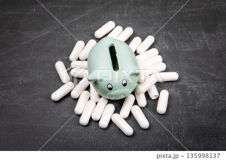 Health Affordability Concept With Savings Piggy Bank And Medical Capsules Health Affordability Concept With Savings Piggy Bank And Medical Capsules 135998137