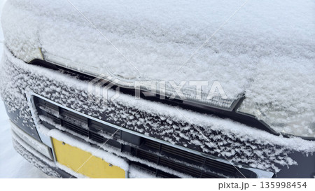 車に積もる雪ヘッドライト　雪国の風景 135998454