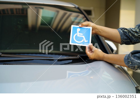 Wheelchair sticker sign on car for safety travel. Wheelchair sticker sign on car for safety travel. 136002351