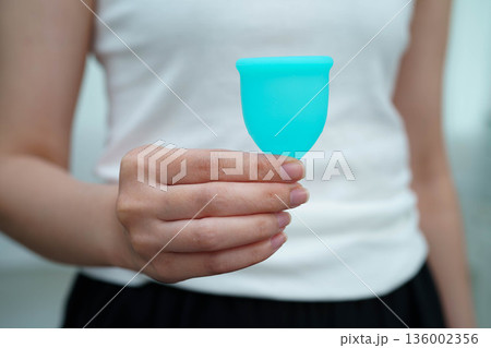 Asian woman holding menstrual cup for hygiene menstrual period cycle protection. Asian woman holding menstrual cup for hygiene menstrual period cycle protection. 136002356