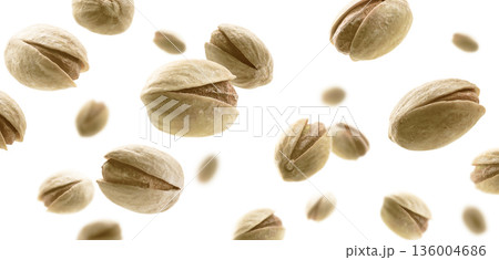 Salted pistachios levitate on a white background Salted pistachios levitate on a white background 136004686
