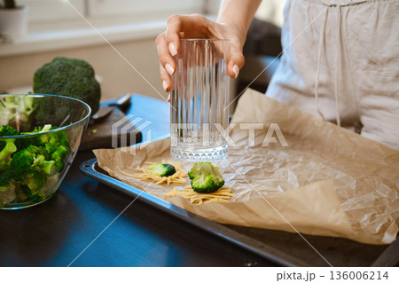 Preparation of smashed broccoli with cheese for a healthy meal Preparation of smashed broccoli with cheese for a healthy meal 136006214