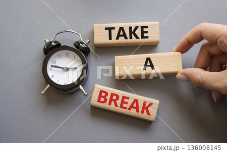Take a break symbol. Concept words Take a break on wooden blocks. Businessman hand. Beautiful grey background with alarm clock. Business and Take a break concept. Copy space. 136008145