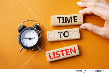 Time to listen symbol. Concept words Time to listen on wooden blocks. Businessman hand. Beautiful orange background with alarm clock. Business and Time to listen concept. Copy space. Time to listen symbol. Concept words Time to listen on wooden blocks. Businessman hand. Beautiful orange background with alarm clock. Business and Time to listen concept. Copy space. 136008149