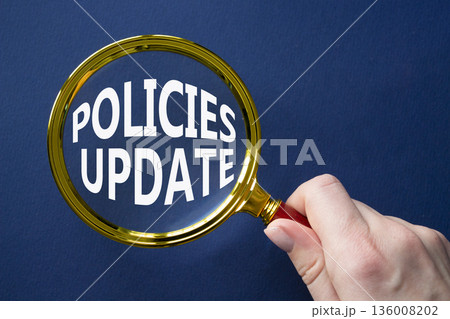 Policies Update symbol. Magnifying Glass with words Policies Update. Businessman hand. Beautiful deep blue background. Business and Policies Update concept. Copy space. Policies Update symbol. Magnifying Glass with words Policies Update. Businessman hand. Beautiful deep blue background. Business and Policies Update concept. Copy space. 136008202