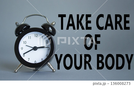 Health symbol. Wooden blocks with words Take Care of your Body. Beautiful grey background with alarm clock. Health concept. Copy space. 136008273