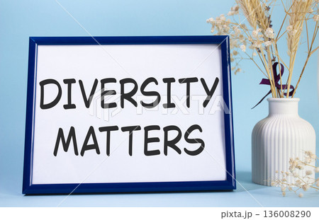 Diversity matters symbol. Concept words Diversity matters on beautiful wooden picture frame. Beautiful light blue background with flower vase. Business and Diversity matters concept. Copy space. 136008290