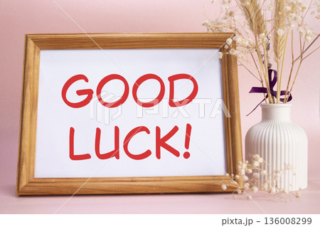 Good luck symbol. Concept words Good luck on beautiful wooden picture frame. Beautiful pink background with flower vase. Business and Good luck concept. Copy space. Good luck symbol. Concept words Good luck on beautiful wooden picture frame. Beautiful pink background with flower vase. Business and Good luck concept. Copy space. 136008299