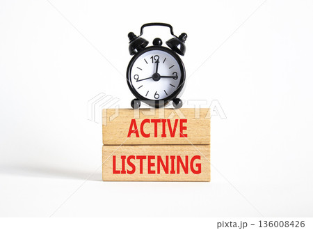 Listen actively symbol. Wooden blocks with words Listen actively. Beautiful white background with alarm clock. Business and Active listening concept. Copy space. 136008426