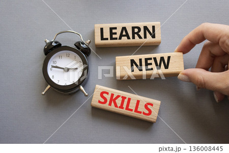 Learn new skills symbol. Concept words Learn new skills on wooden blocks. Businessman hand. Beautiful grey background with alarm clock. Business and Learn new skills concept. Copy space. Learn new skills symbol. Concept words Learn new skills on wooden blocks. Businessman hand. Beautiful grey background with alarm clock. Business and Learn new skills concept. Copy space. 136008445