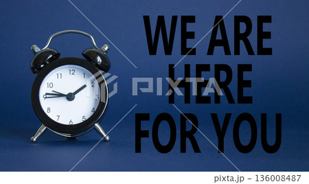 Help symbol. Wooden blocks with words We are here for you. Beautiful deep blue background with alarm clock. Business and We are here for you concept. Copy space. Help symbol. Wooden blocks with words We are here for you. Beautiful deep blue background with alarm clock. Business and We are here for you concept. Copy space. 136008487