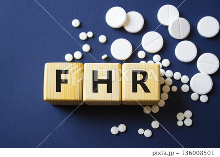FHR symbol. Wooden cubes with words FHR Fetal Heart Rate. Beautiful deep blue background. Healthcare and Fetal Heart Rate concept. Copy space. FHR symbol. Wooden cubes with words FHR Fetal Heart Rate. Beautiful deep blue background. Healthcare and Fetal Heart Rate concept. Copy space. 136008501