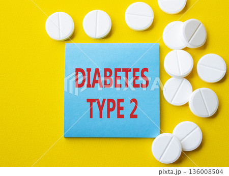 Diabetes Type 2 symbol. Concept word Diabetes Type 2 on blue note. Beautiful yellow background with pills. Medicine and Diabetes Type 2 concept. Copy space 136008504