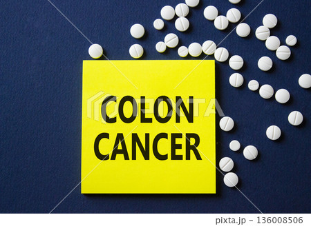 Colon Cancer symbol. Concept word Colon Cancer on yellow note. Beautiful deep blue background with pills. Medicine and Colon Cancer concept. Copy space Colon Cancer symbol. Concept word Colon Cancer on yellow note. Beautiful deep blue background with pills. Medicine and Colon Cancer concept. Copy space 136008506