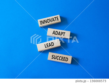 Innovate Adapt Lead Succeed symbol. Concept words Innovate Adapt Lead Succeed on wooden blocks. Beautiful bright blue background. Business and Innovate Adapt Lead Succeed concept. Copy space. 136008573