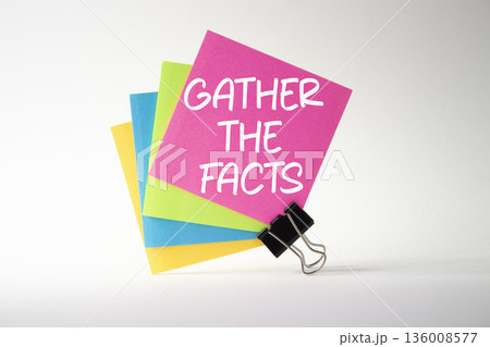 Gather the facts symbol. Pink sticky note with paper clips with words Gather the facts. Beautiful deep blue background. Business and Gather the facts concept. Copy space. Gather the facts symbol. Pink sticky note with paper clips with words Gather the facts. Beautiful deep blue background. Business and Gather the facts concept. Copy space. 136008577