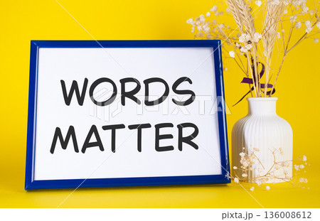 Words Matter symbol. Concept words Words Matter on beautiful wooden picture frame. Beautiful yellow background with flower vase. Business and Words Matter concept. Copy space. Words Matter symbol. Concept words Words Matter on beautiful wooden picture frame. Beautiful yellow background with flower vase. Business and Words Matter concept. Copy space. 136008612