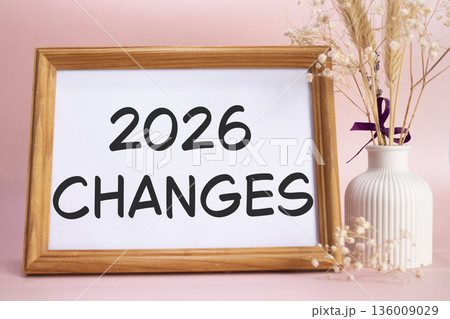 2026 Changes symbol. Concept words 2026 Changes on beautiful wooden picture frame. Beautiful pink background with flower vase. Business and 2026 Changes concept. Copy space. 2026 Changes symbol. Concept words 2026 Changes on beautiful wooden picture frame. Beautiful pink background with flower vase. Business and 2026 Changes concept. Copy space. 136009029